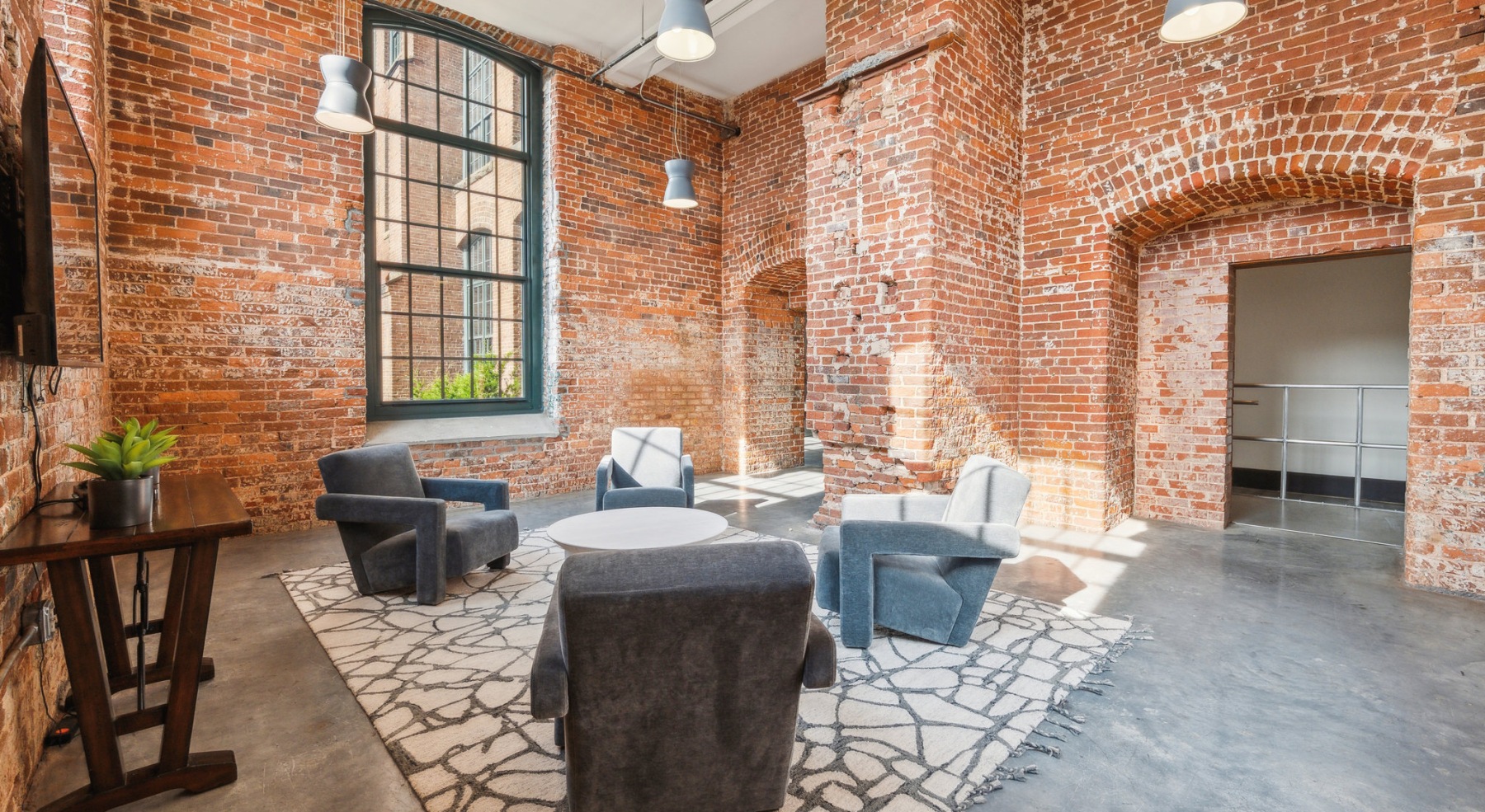 seating area with bring walls and a large window