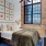 a bedroom with a bed and a mirror