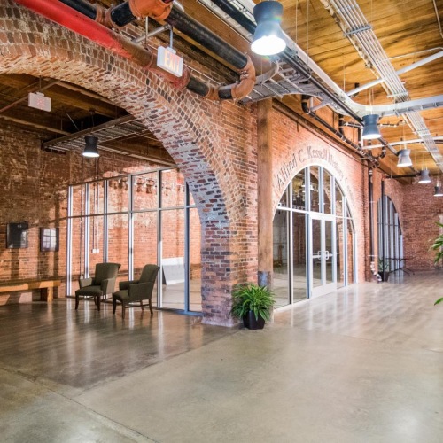 a large room with a large glass ceiling and a large arched doorway